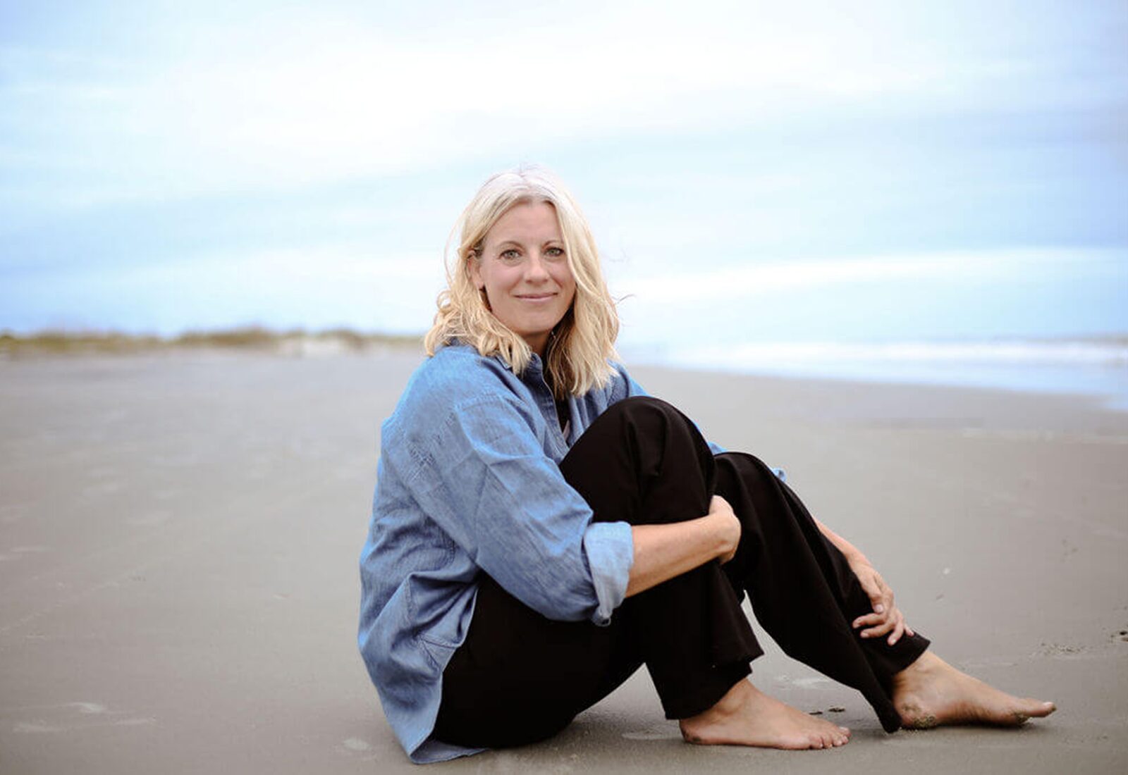 Jolene Park sitting and smiling warmly at the shore